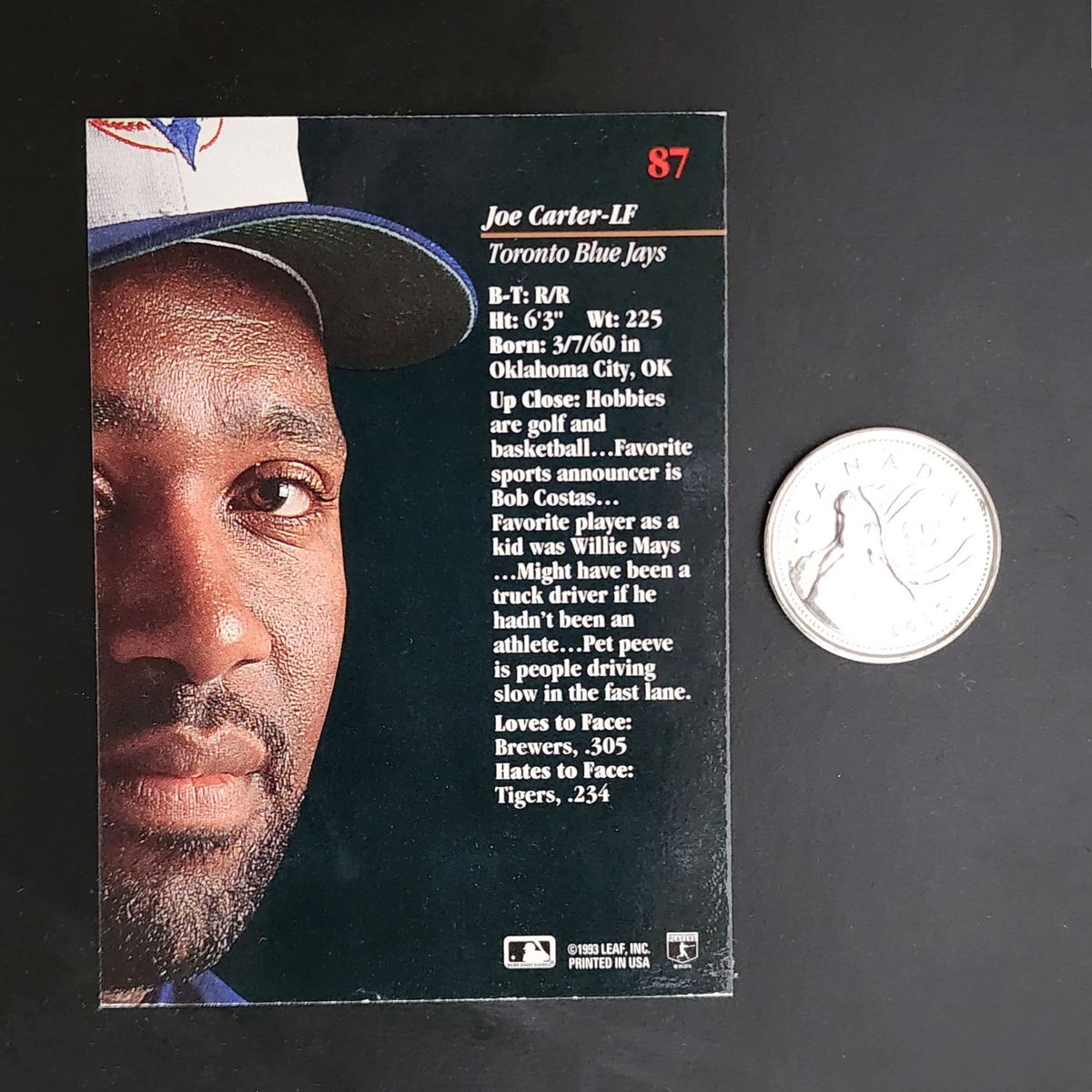 A baseball card featuring a coin beside it, showcasing a valuable collectible item.