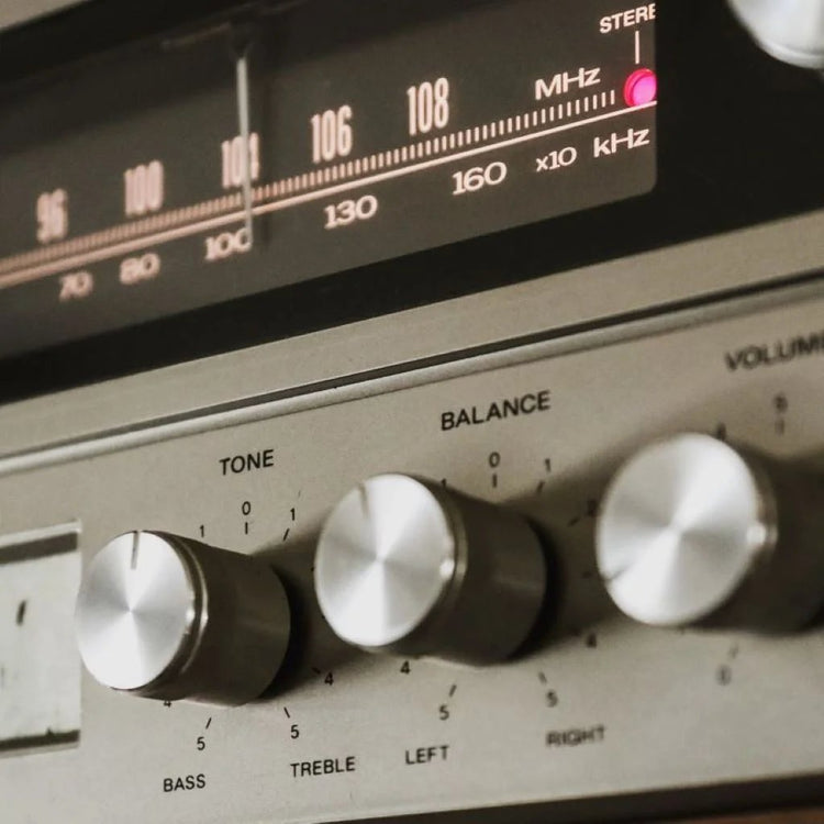 A close-up view of an antique radio featuring various knobs and buttons, showcasing its vintage design and craftsmanship.