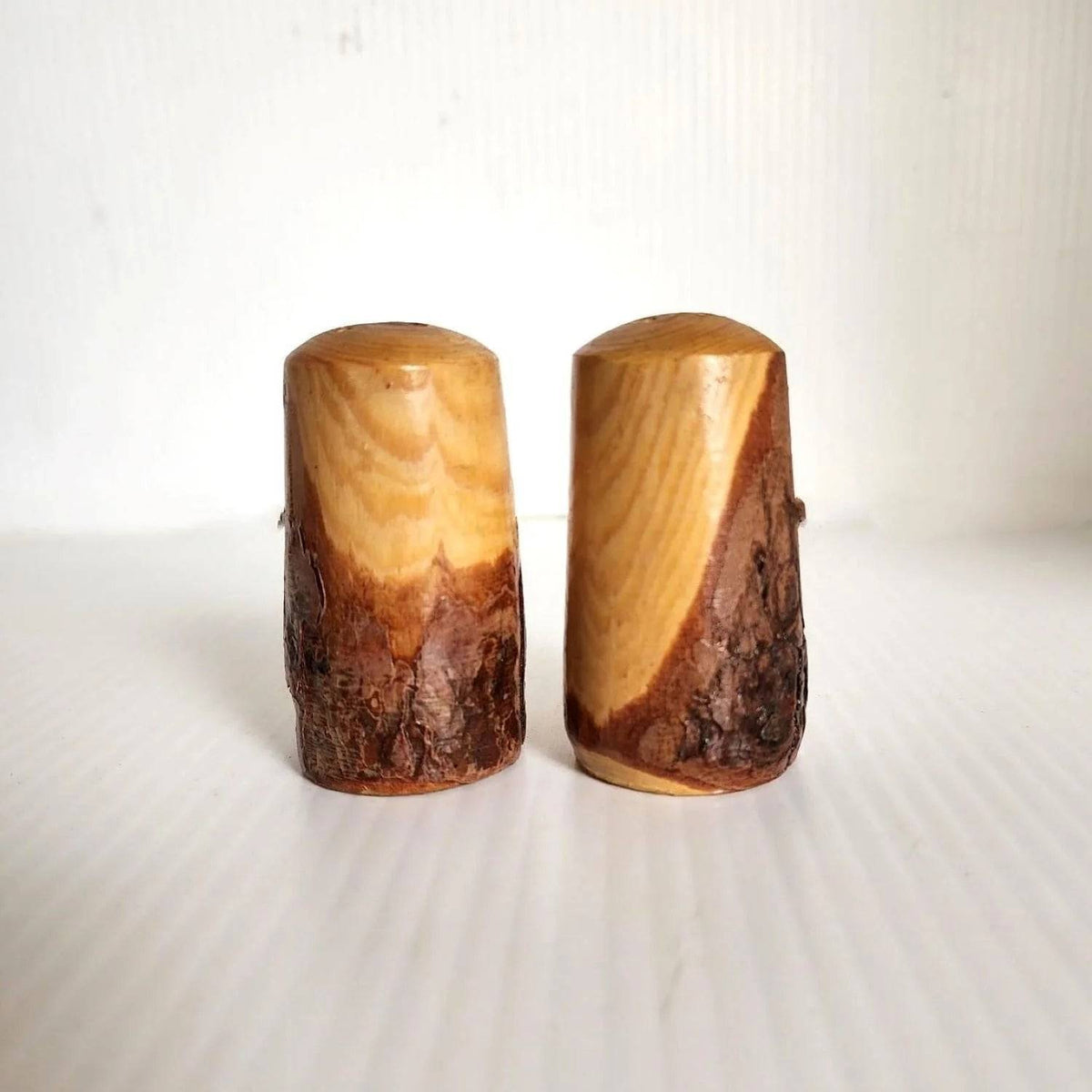Wooden salt and pepper shakers featuring deer designs.