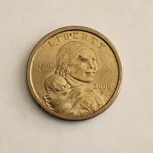 An elegant coin design showcasing a woman tenderly holding a baby, representing the essence of maternal care and devotion.